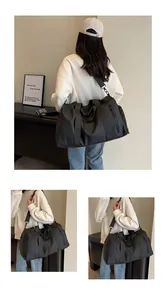 Detailed view of black travel bag with waterproof nylon fabric and durable shoulder strap