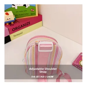 Detail view of pink and yellow striped bag with an adjustable textile shoulder strap