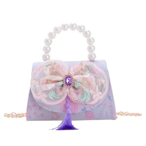 Kids lavender floral handbag with pearl handle, lace bow, and elegant purple tassel