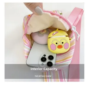 Internal capacity of stripe canvas mini bag showing phone, earphones and accessories