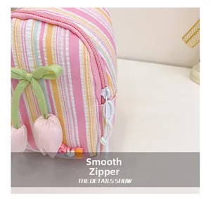 Close-up of smooth white zipper on pink striped tulip crossbody bag for girls