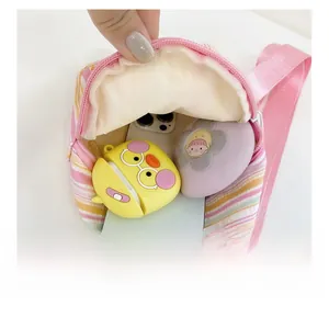 Detail view of colorful striped crossbody bag showing internal space for phone and earphones