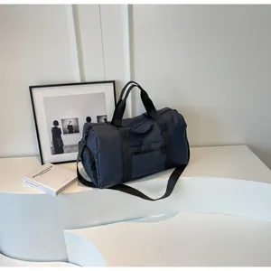 Detail view of large navy blue travel bag featuring durable waterproof nylon fabric