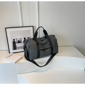 Deep grey travel bag featuring a dedicated shoe compartment and durable nylon handles