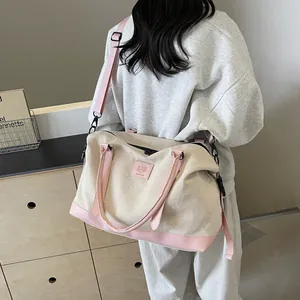 Minimalist canvas travel tote bag with pink leather trim and adjustable strap shown on model