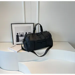 Detail of black waterproof travel bag with adjustable strap and side zipper pockets