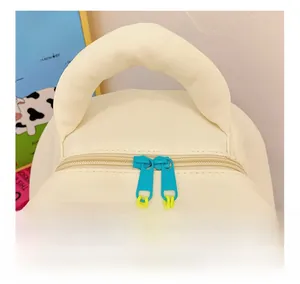 Detail show of smooth yellow cord zippers and sturdy top handle on kids dinosaur backpack