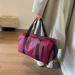 Large capacity burgundy travel bag with shoe compartment and durable woven handles