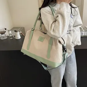 Canvas travel tote bag with mint green leather trim shown in casual lifestyle setting