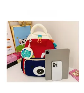 Size comparison of dinosaur backpack and mini pouch next to a tablet and smartphone