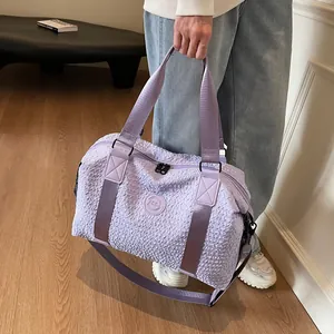 Detail of light purple travel bag featuring a unique bubble textured fabric and dual handles
