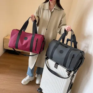 Detail of burgundy and grey travel bags with separate shoe compartment and waterproof fabric