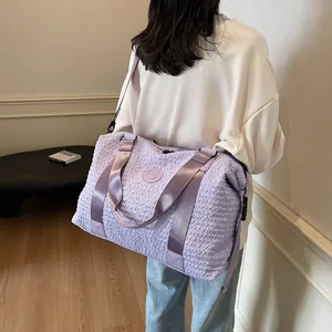 Detail of light purple large capacity travel bag with textured waterproof fabric