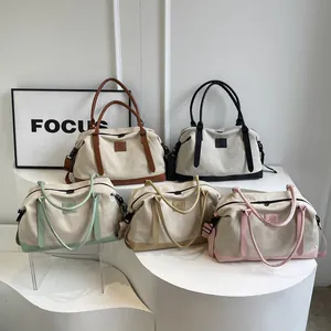 Five assorted colors of stylish canvas travel tote bags with detachable shoulder straps