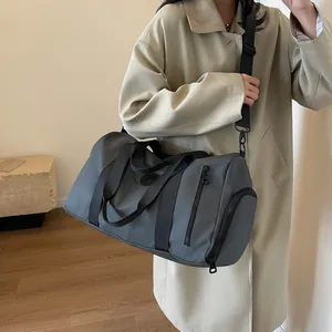 Close-up of high-capacity grey fitness travel bag featuring a side separate shoe compartment