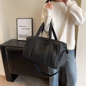 Large capacity black travel bag with side compartment and adjustable shoulder strap