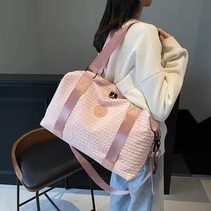 Pink pleated texture duffel bag on model showing large capacity and size ratio