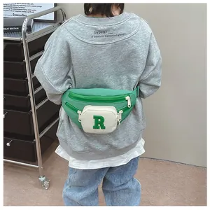 Kids color-block waist bag in green and white with plush R letter and nylon strap