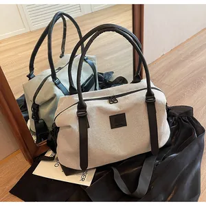Detail showing high-quality canvas stitching and leather handle on a minimalist tote bag