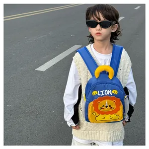 Detail of durable blue toddler backpack featuring a cute orange cartoon lion and LION text