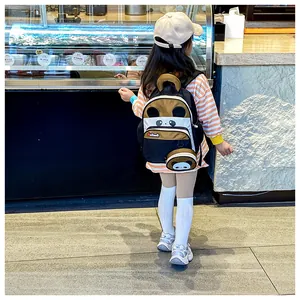Toddler panda backpack with detachable coin purse shown on a child in a shop setting