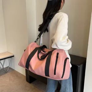 Detailed side view of a pink large-capacity travel bag with independent shoe compartment