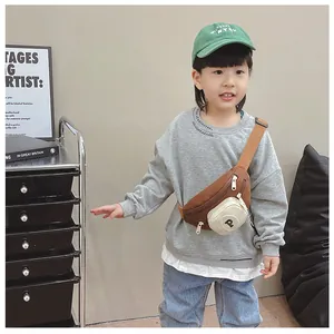 Detailed view of child wearing a brown nylon sling bag with a white P letter pocket