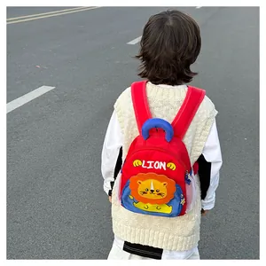 Rear view of a kids lion backpack showing red adjustable straps and blue top handle