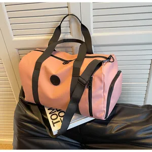Close-up of pink travel bag featuring a side shoe compartment and black nylon straps