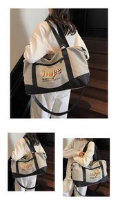 Large travel bag with adjustable strap and hope letter print on soft beige fabric