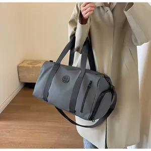 Detail of grey travel bag with shoe compartment and waterproof nylon texture