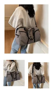 Vista dettagliata della borsa da viaggio grigia multifunzionale con logo FRAME e tracolla