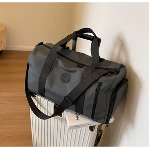 Detail of travel duffel bag with strap secured on white suitcase handle for travel