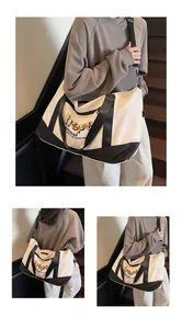 Detail of durable black canvas handles and metal adjustment buckle on the large travel bag