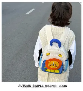 Detail of cute cartoon lion backpack with blue mesh side pocket and soft top handle