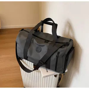 Large dark grey travel bag with waterproof fabric and separate shoe compartment on suitcase
