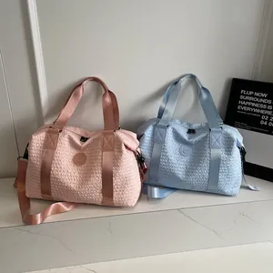 Detail showing high-capacity travel bags with textured fabric and shoulder straps