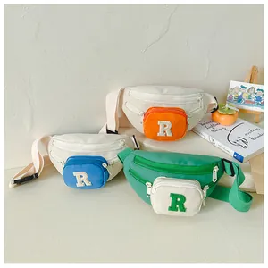 Three colorful kids' canvas chest bags with 'R' patches and adjustable straps