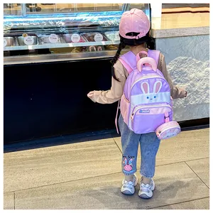 Detail of cute purple bunny kids backpack with matching small round bag and 3D rabbit ears
