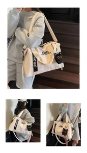Detail of travel bag showing cute cat ears pattern and black plush cat charm accessory