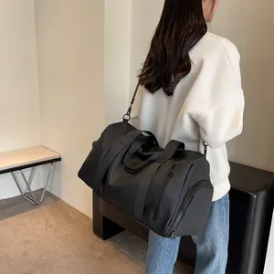 Large capacity black travel duffel bag with shoulder strap and shoe compartment