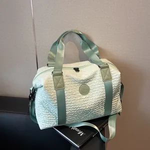 Macro detail of mint green textured travel bag with ZSSJ logo on a sleek black seat
