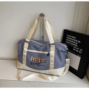 Detail of grey-blue travel bag with waterproof nylon texture and brand lettering