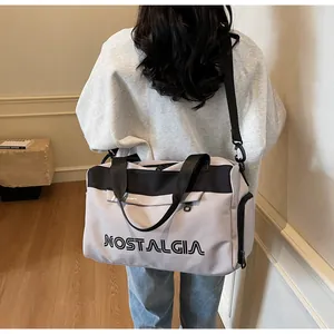 Light gray multi-functional travel bag with adjustable strap and Nostalgia print detail