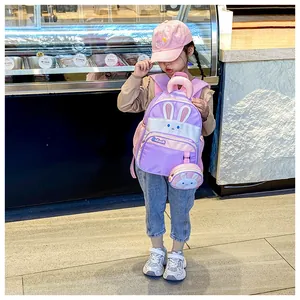 Detail of purple waterproof nylon kids backpack with cute rabbit pattern and round coin purse