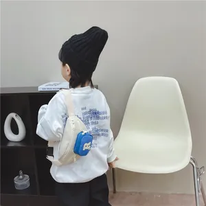 Off-white kids' crossbody chest bag with blue pouch and adjustable strap, back view