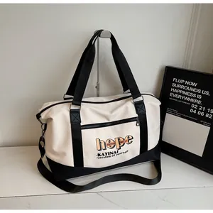 Detail view of large travel bag showing hope letter print and durable canvas texture
