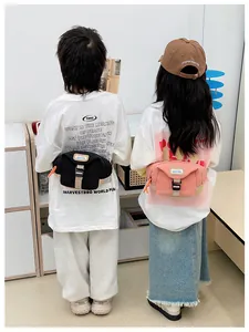 Rear view of children wearing casual canvas waist bags showing fit and adjustable buckles