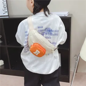 Kids cream canvas chest bag with orange R letter pouch and adjustable shoulder strap
