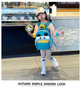 Outdoor shot of a girl wearing a panda theme kids backpack with a matching coin purse